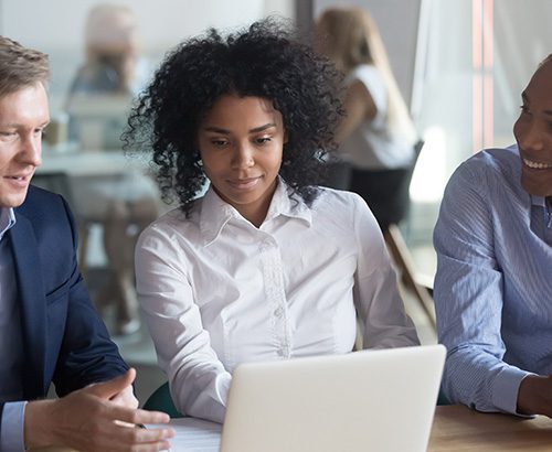 Business team looking at a laptop